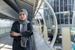 Portrait of female muslim wear hijab and black suit hands crosse